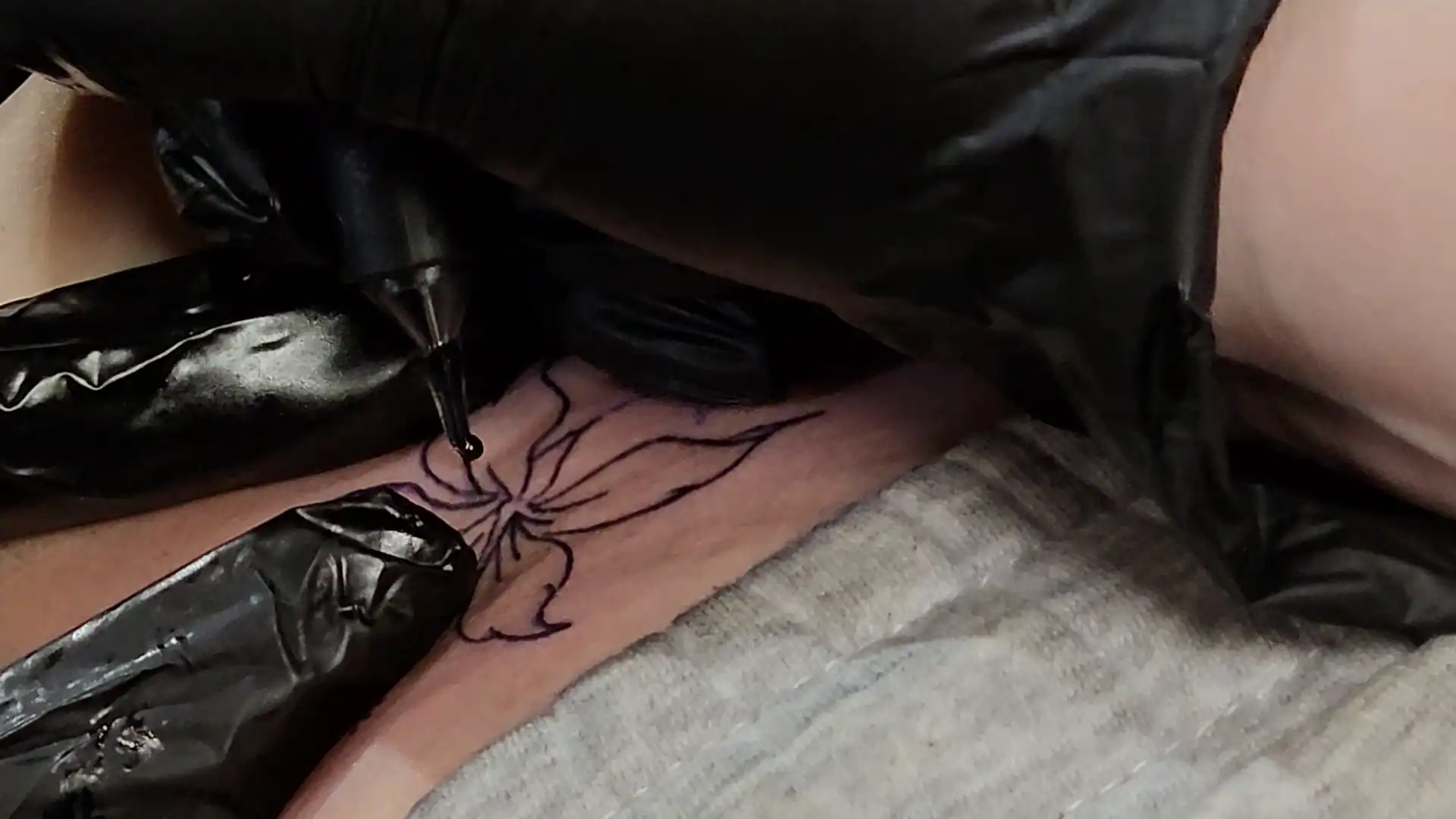 Closeup of hands doing a tattoo